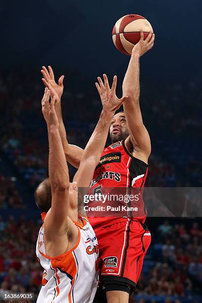 Everard Bartlett of the Wildcats shoots against Dusty Rychart of the Taipans during the round 23 NBL match between the Perth Wildcats and the Cairns...