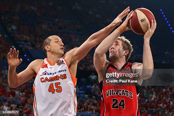 Dusty Rychart of the Taipans looks to block Jesse Wagstaff of the Wildcats during the round 23 NBL match between the Perth Wildcats and the Cairns...