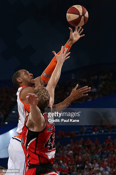 Shane Edwards of the Taipans lays up against Shawn Redhage of the Wildcats during the round 23 NBL match between the Perth Wildcats and the Cairns...