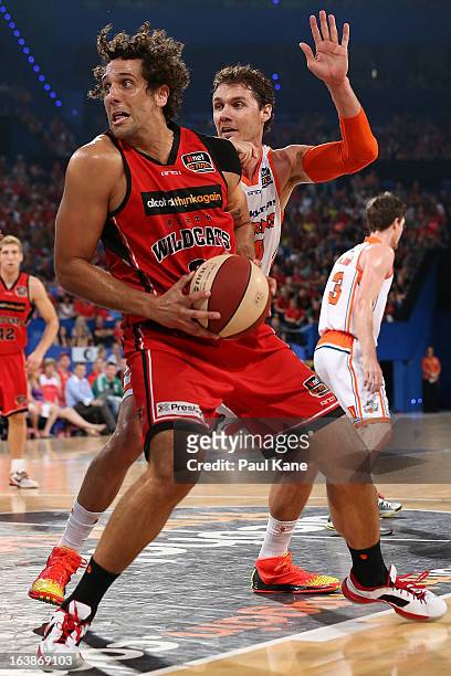 Alex Loughton of the Taipans holds out Matthew Knight of the Wildcats during the round 23 NBL match between the Perth Wildcats and the Cairns Taipans...