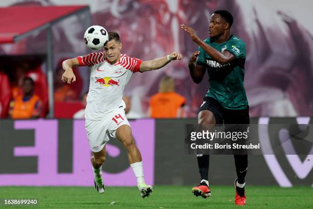 Christoph Baumgartner of RB Leipzig runs with the ball whilst under pressure from Dan-Axel Zagadou of VfB Stuttgart during the Bundesliga match...
