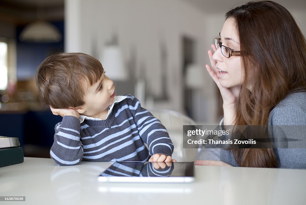 Small boy talking to his mother