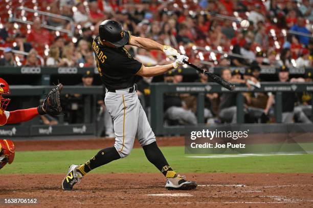 Bryan Reynolds of the Pittsburgh Pirates hits a sacrifice fly against the St. Louis Cardinals in the tenth inning at Busch Stadium on September 1,...