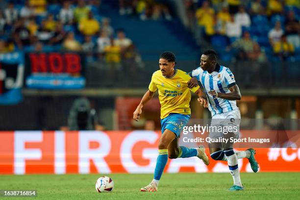 Saul Coco of UD Las Palmas competes for the ball with Umar Sadiq of Real Sociedad during the LaLiga EA Sports match between UD Las Palmas and Real...