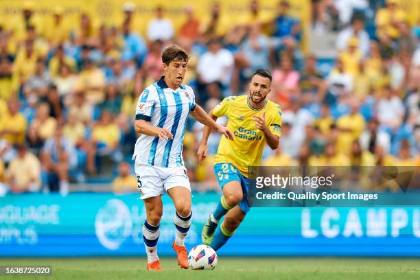 Kirian Rodriguez of UD Las Palmas competes for the ball with Aihen Munoz of Real Sociedad during the LaLiga EA Sports match between UD Las Palmas and...