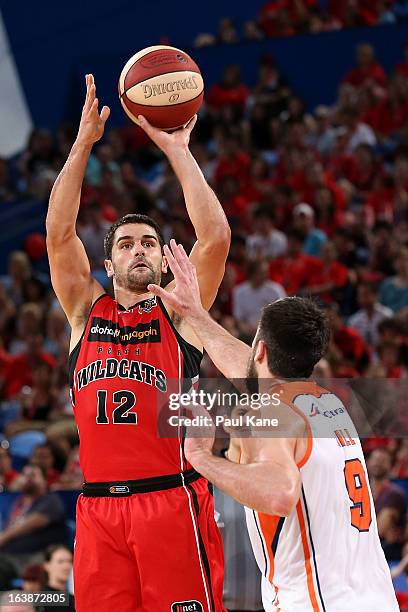 Kevin Lisch of the Wildcats shoots against Brad Hill of the Taipans during the round 23 NBL match between the Perth Wildcats and the Cairns Taipans...