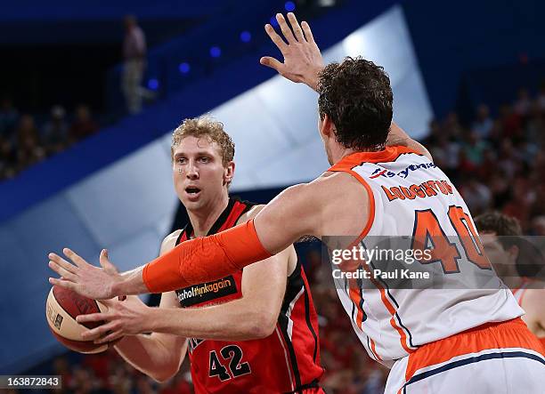 Shawn Redhage of the Wildcats looks to pass the ball against Alex Loughton of the Taipans during the round 23 NBL match between the Perth Wildcats...