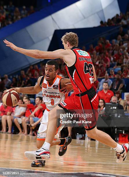 Aaron Grabau of the Taipans looks to drive past Shawn Redhage of the Wildcats during the round 23 NBL match between the Perth Wildcats and the Cairns...