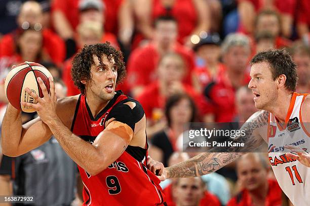 Cameron Tragardh of the Taipans holds off Matthew Knight of the Wildcats during the round 23 NBL match between the Perth Wildcats and the Cairns...