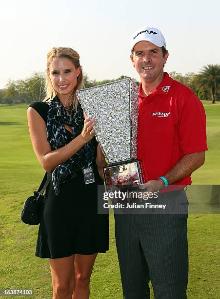 Thomas Aiken of South Africa with his wife Kate Aiken pose with the winners trophy during day four of the Avantha Masters at Jaypee Greens Golf Club...