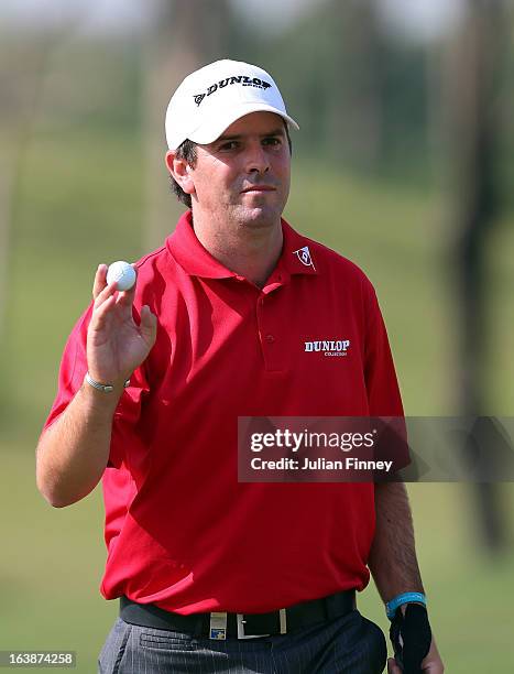 Thomas Aiken of South Africa thanks the support after a putt during day four of the Avantha Masters at Jaypee Greens Golf Club on March 17, 2013 in...