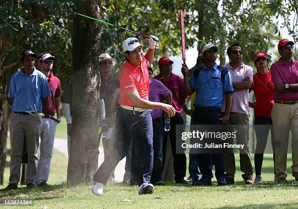 Liang Wenchong of China plays out of trees during day four of the Avantha Masters at Jaypee Greens Golf Club on March 17, 2013 in Delhi, India.
