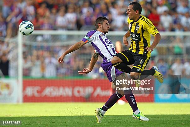 Joshua Risdon of the Perth Glory tackles Leo Bertos of the Wellington Phoenix during the round 25 A-League match between the Perth Glory and the...