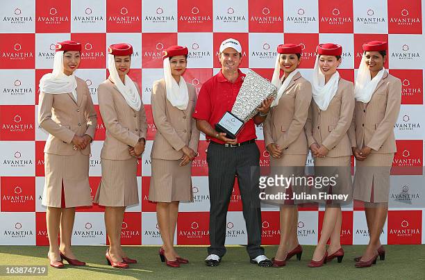 Thomas Aiken of South Africa poses with the winners trophy and the Emirates girls during day four of the Avantha Masters at Jaypee Greens Golf Club...