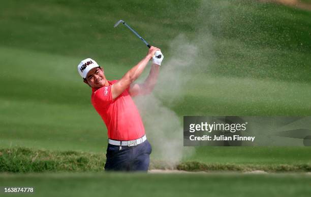 Liang Wenchong of China plays out of a bunker on hole 11 during day four of the Avantha Masters at Jaypee Greens Golf Club on March 17, 2013 in...