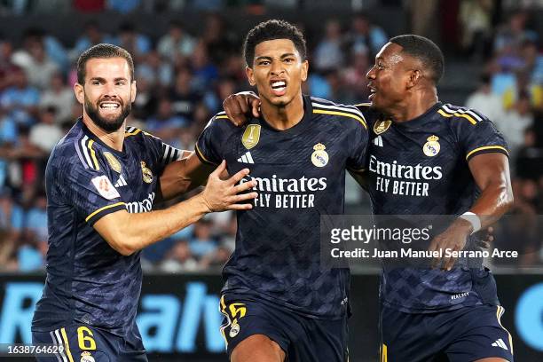Jude Bellingham of Real Madrid celebrates with teammates Nacho Fernandez and David Alaba after scoring the team's first goal during the LaLiga EA...
