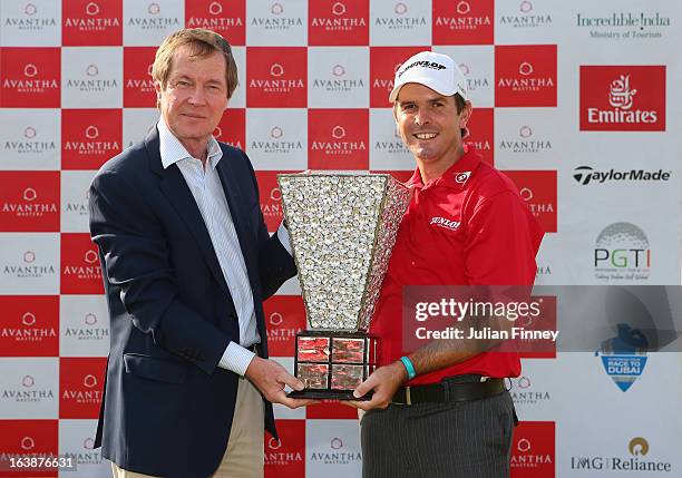 Thomas Aiken of South Africa poses with George O'Grady, CEO of the European Tour with the winners trophy during day four of the Avantha Masters at...