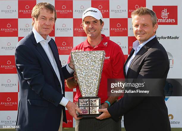 Thomas Aiken of South Africa poses with George O'Grady, CEO of the European Tour and Mike Kerr, CEO of the Asian Tour with the winners trophy during...