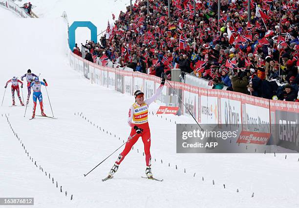 Poland's Justyna Kowalczyk celebrates as she arrives at the finishing line ahead of Russia's Yulia Tchekaleva , Norway's Heidi Wend and Japan's...