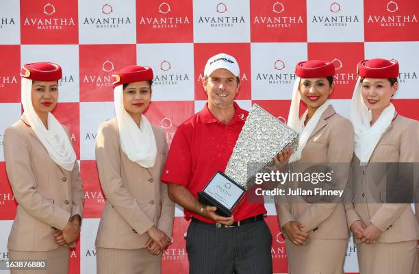 Thomas Aiken of South Africa poses with the winners trophy and the Emirates girls during day four of the Avantha Masters at Jaypee Greens Golf Club...