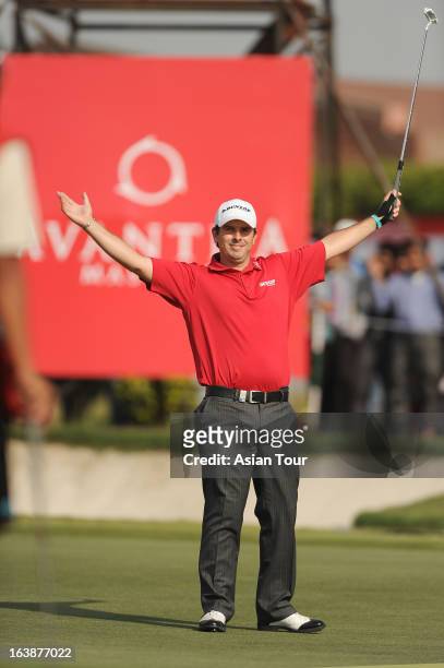 Thomas Aiken of South Africa celebrates at eighteen holes during day 4 of the Avantha Masters at Jaypee Greens Golf Course on March 17, 2013 in...
