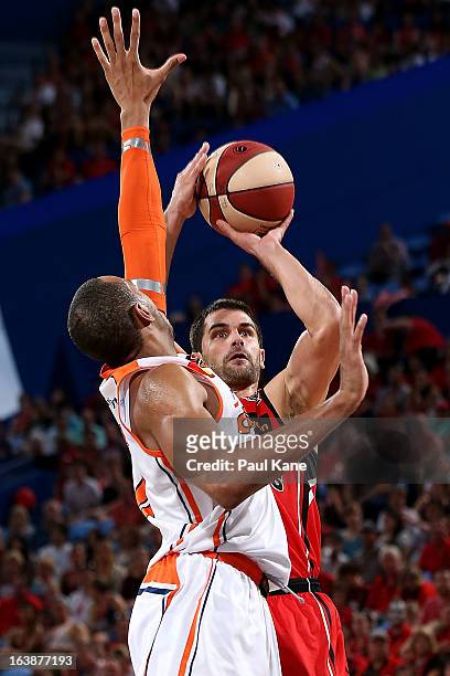 Kevin Lisch of the Wildcats shoots against Shane Edwards of the Taipans during the round 23 NBL match between the Perth Wildcats and the Cairns...