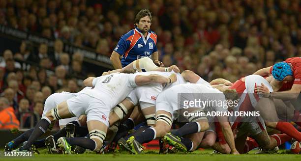 Australian referee Steve Walsh officiates as the scrum collapses during the Six Nations international rugby union match between Wales and England at...