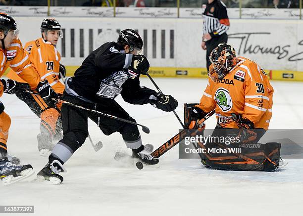 Yan Stastny of Nuremberg is challenged by three players of Wolfsburg including goalie Daniar Dshunussow during game three of the DEL pre-play-offs...