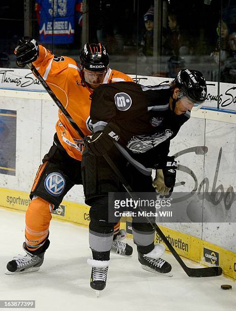 Vincenz Mayer of Wolfsburg challenges Yan Stastny of Nuremberg during game three of the DEL pre-play-offs between Thomas Sabo Ice Tigers and Grizzly...