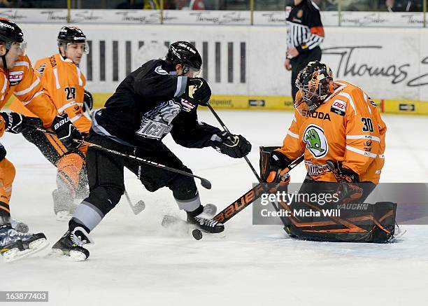 Yan Stastny of Nuremberg is challenged by three players of Wolfsburg including goalie Daniar Dshunussow during game three of the DEL pre-play-offs...