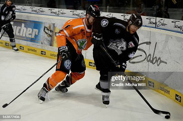 Vincenz Mayer of Wolfsburg challenges Yan Stastny of Nuremberg during game three of the DEL pre-play-offs between Thomas Sabo Ice Tigers and Grizzly...