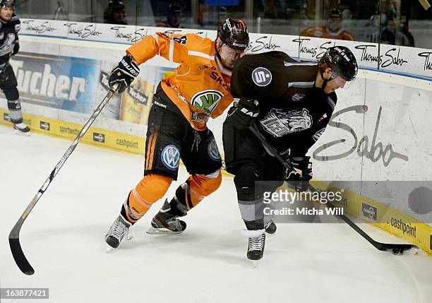 Vincenz Mayer of Wolfsburg challenges Yan Stastny of Nuremberg during game three of the DEL pre-play-offs between Thomas Sabo Ice Tigers and Grizzly...
