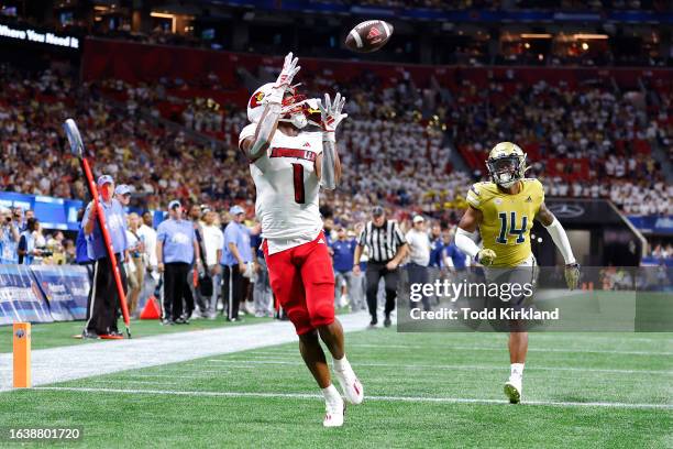 Jamari Thrash of the Louisville Cardinals pulls in a touchdown reception during the second half against the Georgia Tech Yellow Jackets at...