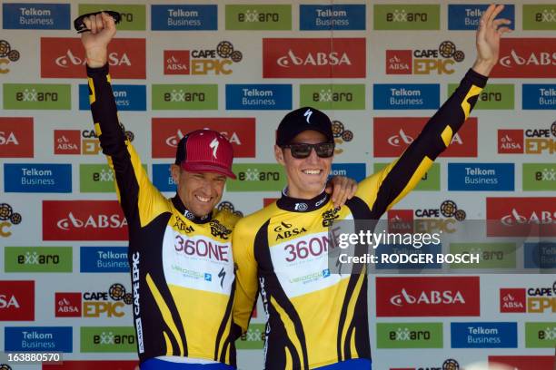 Czech Olympic gold medalist Jaroslav Kulhavy and his teammate Christoph Sauser of Switzerland, riding for the Burry Stander Songo Team, wear yellow...