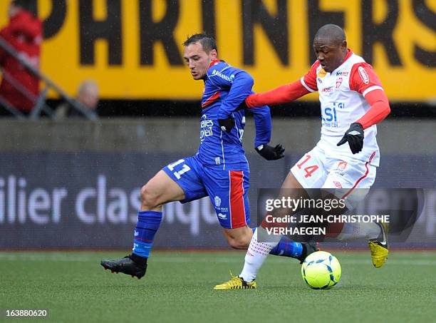 Nancy's Cameroonian forward Paul Alo'o Efoulou fights for the ball with Nice's French forward Eric Bautheac on March 17, 2013 during a French L1...