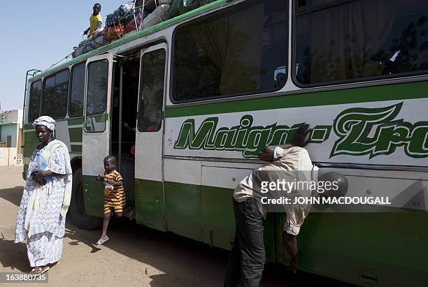 Passenger arriving from the capital Bamako alights from the bus in the northern Malian city of Gao on March 11, 2013. The city's inhabitants who had...