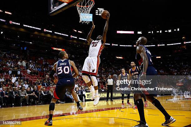 Joel Anthony of the Miami Heat drives to the bastket in front of Dahntay Jones of the Atlanta Hawks at American Airlines Arena on March 12, 2013 in...