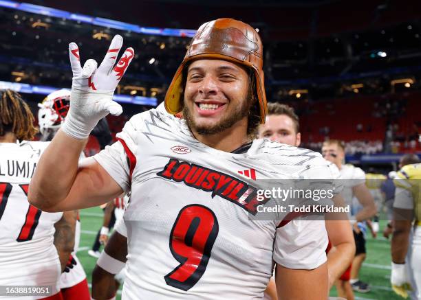 Ashton Gillotte of the Louisville Cardinals wears the old leather helmet following the victory over the Georgia Tech Yellow Jackets at Mercedes-Benz...