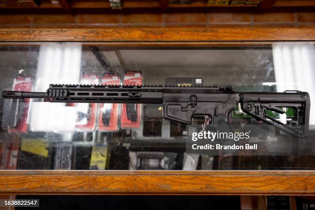 In this photo illustration, a semi-automatic AR-15 is displayed on a countertop at the McBride Guns Inc. Store on August 25, 2023 in Austin, Texas....