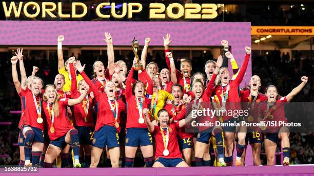 Ivana Andrés of Spain lifts the Women's World Cup trophy and players celebrate the winning of the tournament during the ceremony after the FIFA...