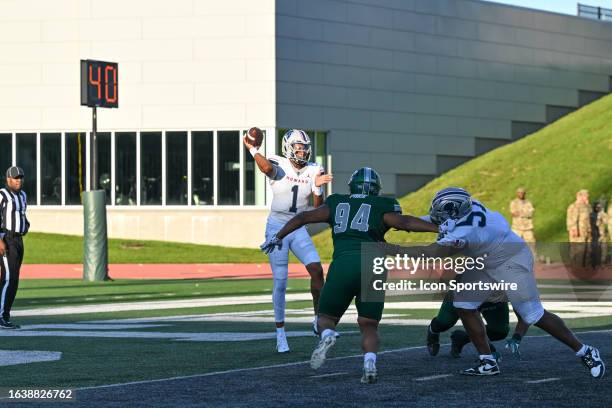 Howard Bison quarterback Quinton Williams throws under pressure from Eastern Michigan Eagles defensive lineman Peyton Price during the game between...