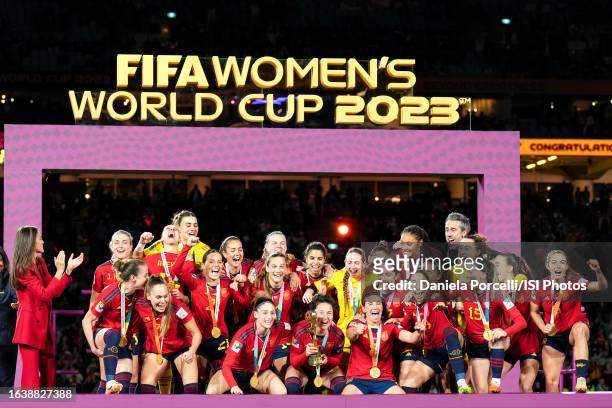 Ivana Andrés of Spain lifts the Women's World Cup trophy and players celebrate the winning of the tournament during the ceremony after the FIFA...