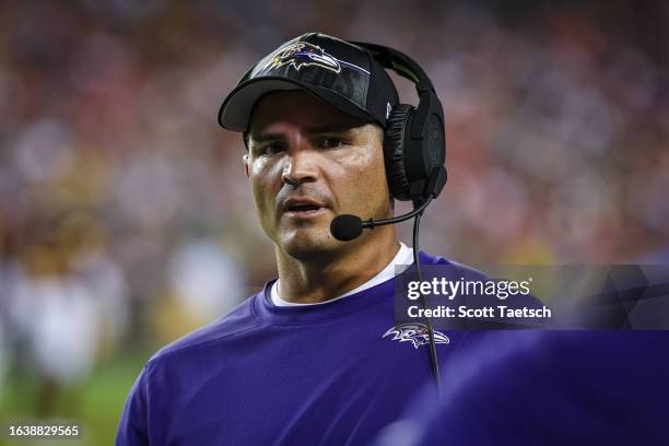 Defensive coordinator Mike Macdonald of the Baltimore Ravens looks on during the first half of the preseason game against the Washington Commanders...