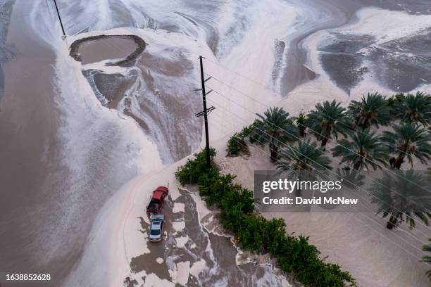 In an aerial view, cars are stranded in the waters of a flash flood caused by a monsoonal thunderstorm that quickly dropped three inches of rain on a...