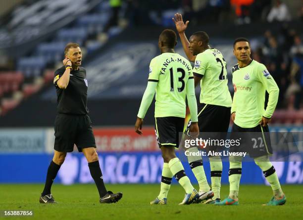 The Newcastle United players protest to Referee Mark Halsey after the second Wigan goal during the Barclays Premier League match between Wigan...