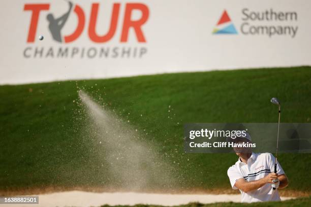 Russell Henley of the United States plays a shot from a bunker on the 18th hole during the second round of the TOUR Championship at East Lake Golf...