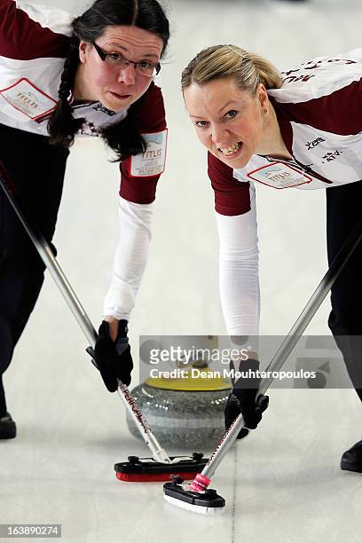 Zanda Bikse and Dace Munca of Latvia sweep in the match between Latvia and Japan during Day 2 of the Titlis Glacier Mountain World Women's Curling...