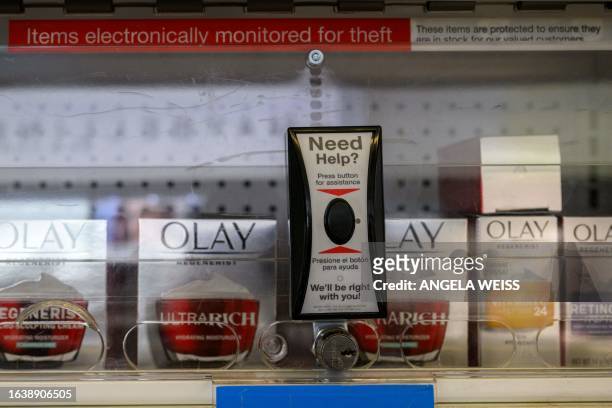 Locked up items to prevent shoplifting and assistance button are seen at a Duane Reade drugstore and pharmacy on August 24, 2023 in New York City....