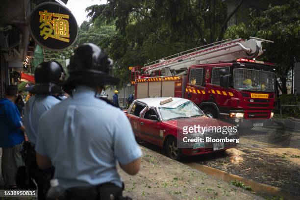 Taxi damaged by a fallen tree following Super Typhoon Saola in Hong Kong, China, on Saturday, Sept. 2, 2023. Severe Typhoon Saola began to weaken and...