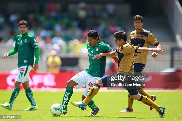 Efrain Velarde of Pumas struggles for the ball with Carlos Pena of Leon during a match between Santos and Leon as part of Clausura 2013 Liga MX at...